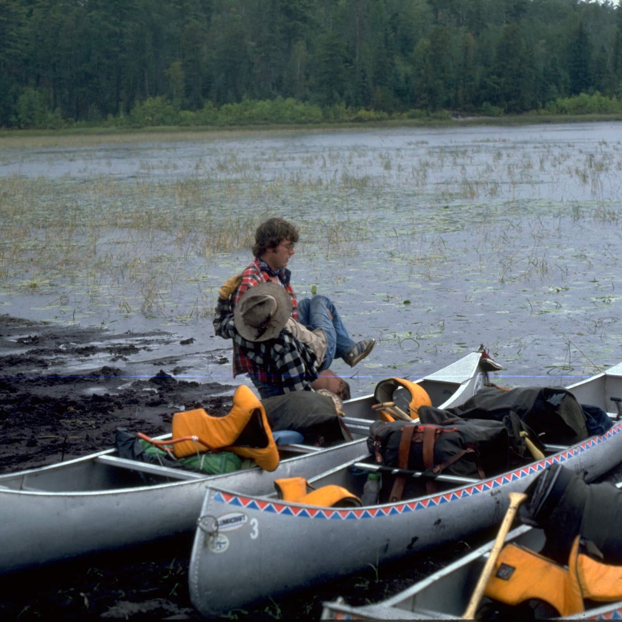 Greg Lais transfers Ted Oftedahl on WI's first trip in 1977. This is the portage into Lac La Croix.
